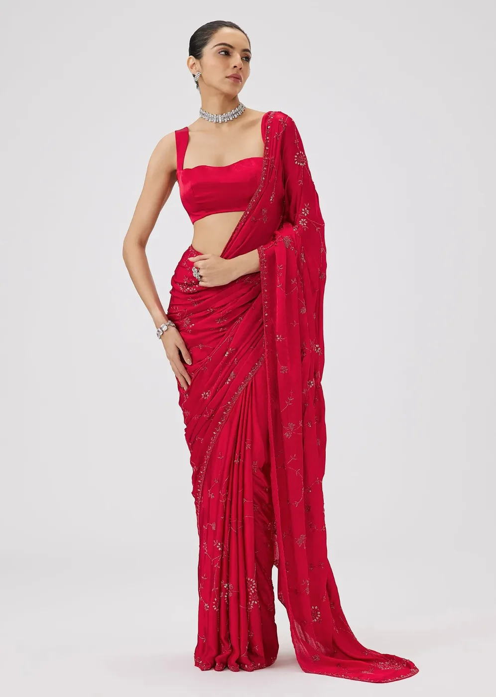 Model in a red embroidered chinon saree with floral sequin jaal