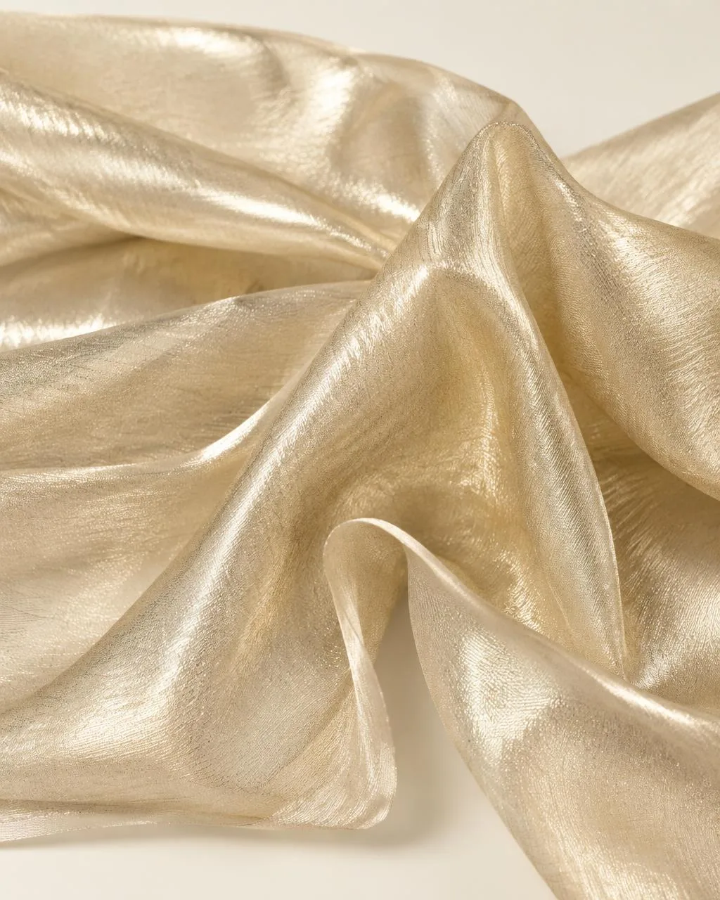 Champagne gold metallic tissue fabric in luminous folds