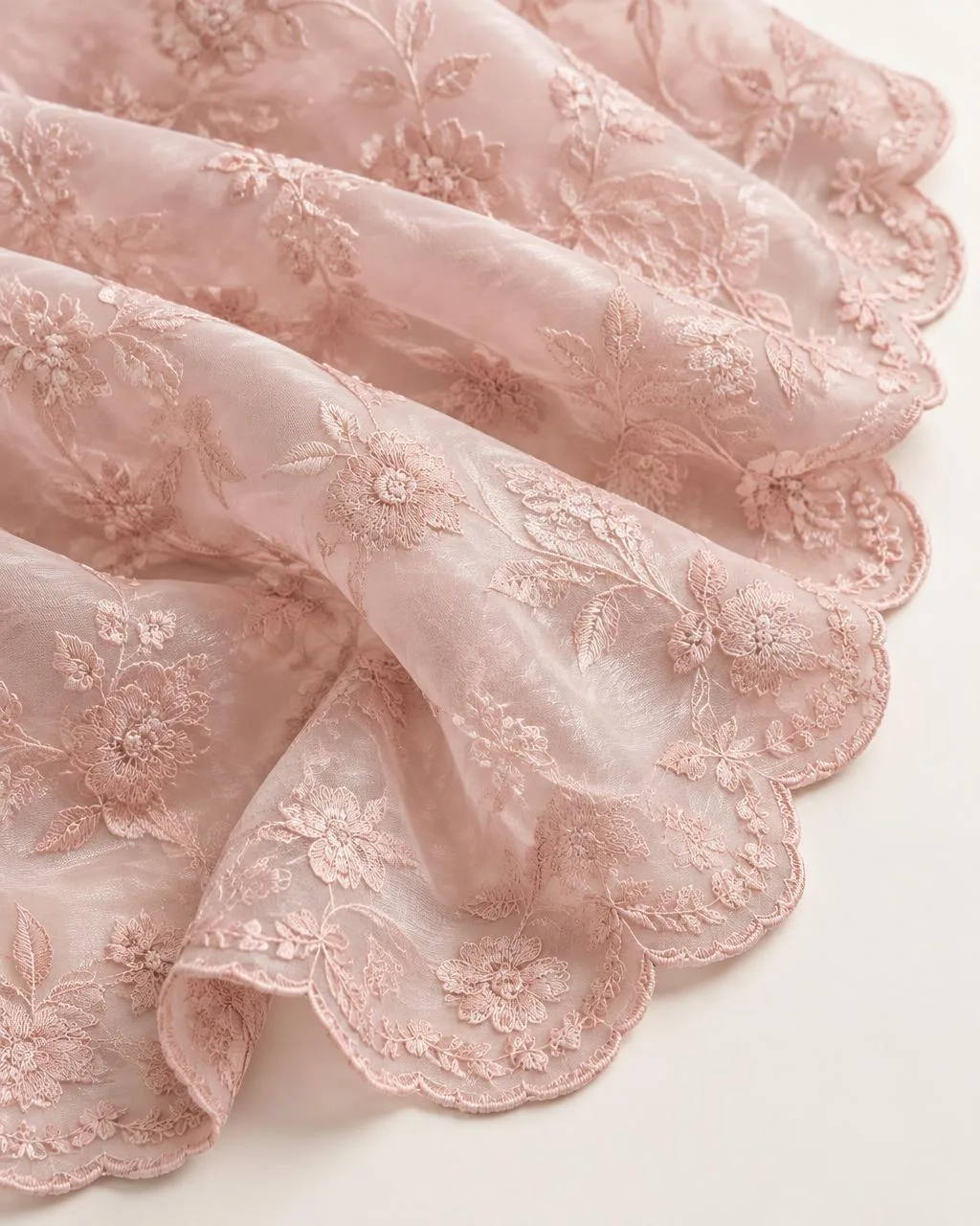 Blush pink organza fabric with tonal floral thread embroidery and scalloped edge
