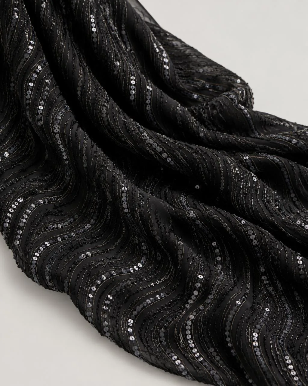 Black georgette fabric with gunmetal sequin embroidery in a wave pattern