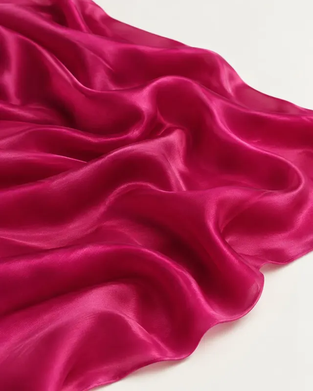 Rani pink chinon fabric flowing in soft ripples