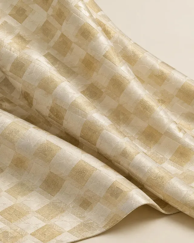 Ivory and pale gold geometric jacquard fabric draped in folds