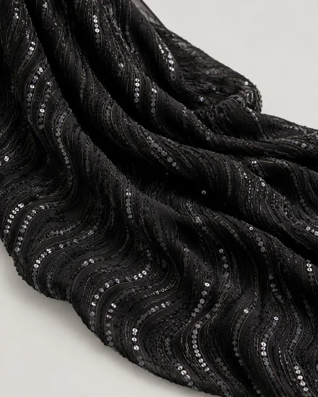 Black georgette fabric with gunmetal sequin embroidery in a wave pattern