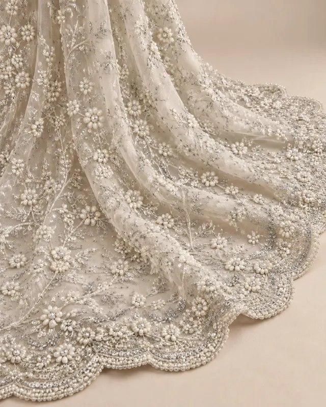 Ivory net with pearl, crystal and sequin floral embellishment and scalloped border