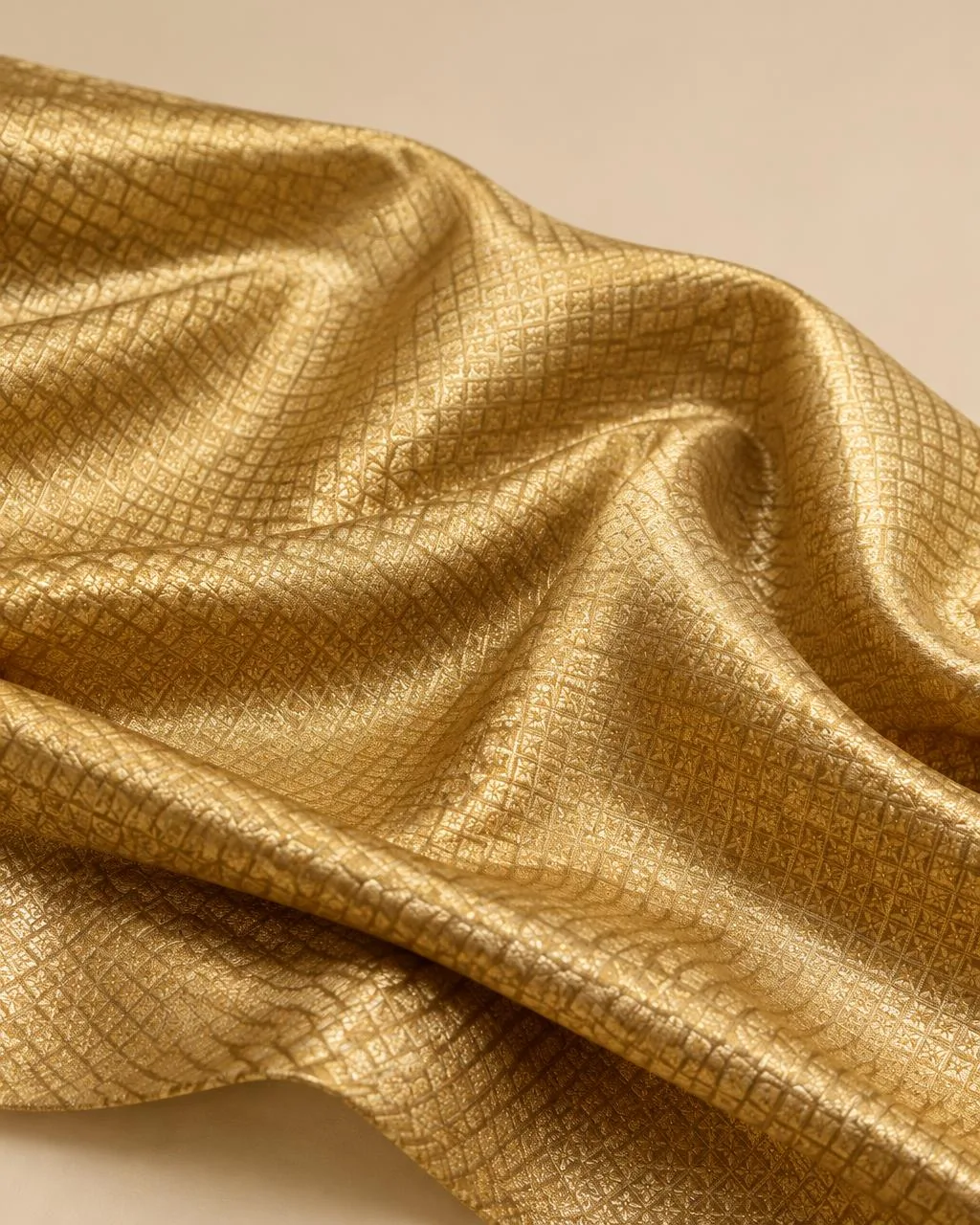 Antique gold zari-woven fabric with fine diamond texture in soft folds